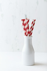 Paper  straws in a ceramic milk bottle