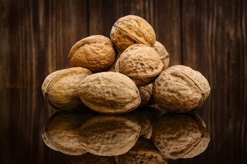 Walnuts on old wooden background