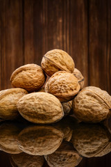 Walnuts on old wooden background