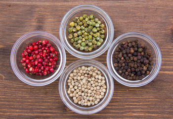 Bowls with mixed peppers on wooden table top views