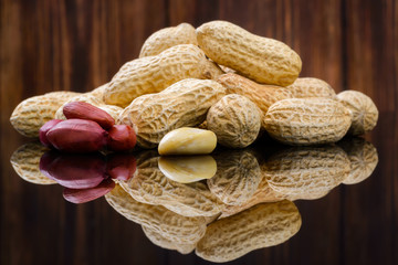 Peanuts in shells on wood background