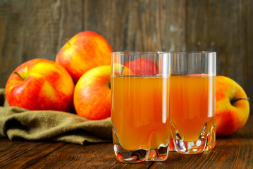 Apple juice and apples on wooden table. Selective focus