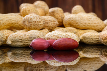 Peanuts in shells on wood background