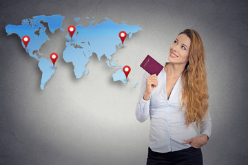 tourist young woman holding passport looking at world map