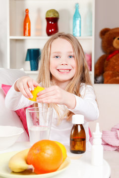 Little Girl Squeezing Lemon To Water