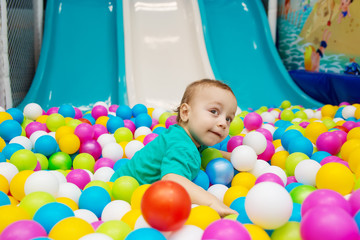little boy playing with balls