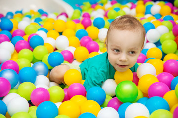 Fototapeta na wymiar little boy playing with balls