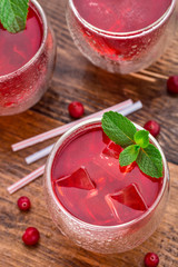 Cranberry cocktail with mint garnish.
