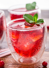 Cranberry cocktail with mint garnish.