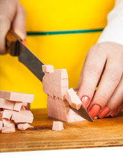 feminine hands cut sausage