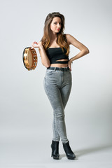 Young woman with tambourine in her hand