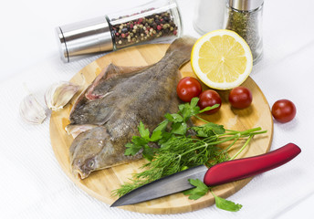 raw fish on a cutting board and knife