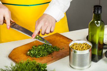 woman finely shred dill