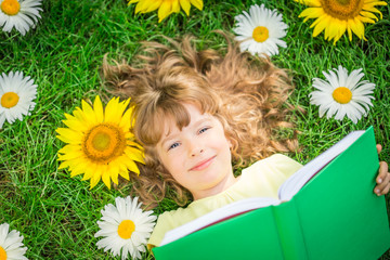 Child reading in park