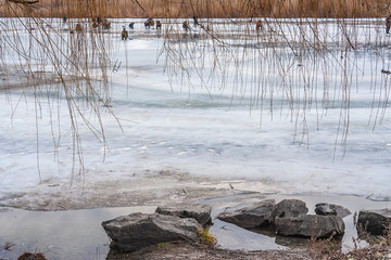 Fototapeta na wymiar Winter landscape with fishermen on the river