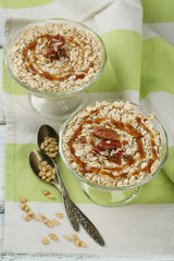 Tasty dessert with oat flakes and honey, on table
