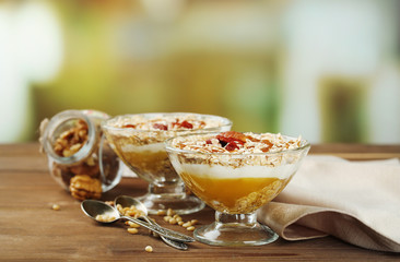 Tasty dessert with oat flakes and honey, on table