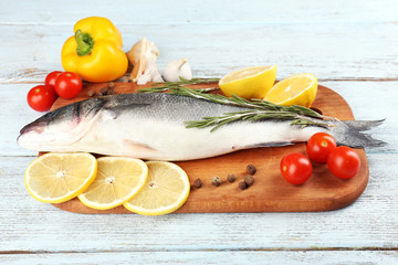 Fresh raw fish and food ingredients on table
