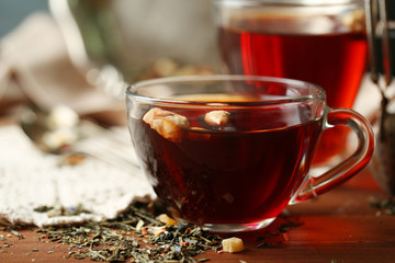 Beautiful vintage composition with herbal tea, on wooden table
