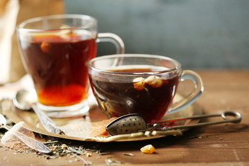 Beautiful vintage composition with herbal tea, on wooden table