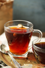 Beautiful vintage composition with herbal tea, on wooden table