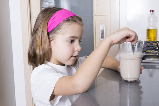 Girl Preparing A Glass Of Milk