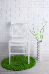 Modern interior with chair on white brick wall background