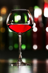 Glass of wine with bar on background