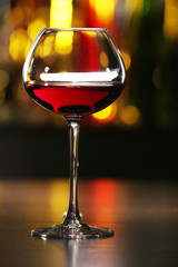 Glass of wine with bar on background