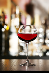 Glass of wine with bar on background