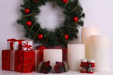 Christmas decoration with wreath, candles and present boxes