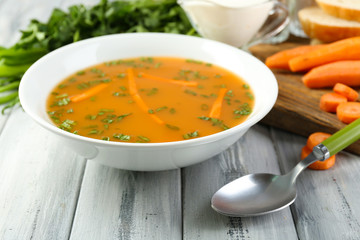 Composition with carrot soup, ingredients and herbs