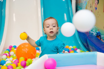 little boy playing with balls