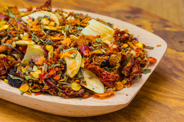 Colored spices for pasta mix on wooden spoon