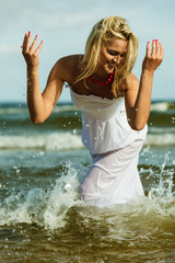 Beautiful blonde girl on beach, summertime