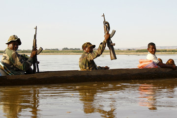 African soldier during operation - transported by traditional ca