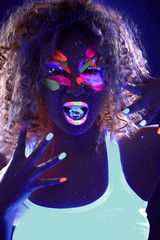 Portrait of curly girl with ice cube in UV light