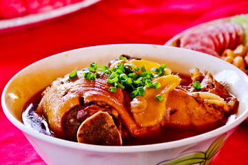 Stewed Pork Pork inside big cup on the red table,is a favorite f