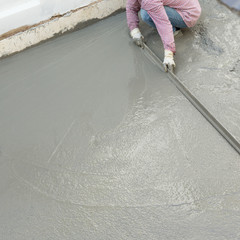 plasterer concrete cement worker plastering flooring of house co
