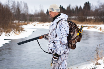 hunter on the river bank