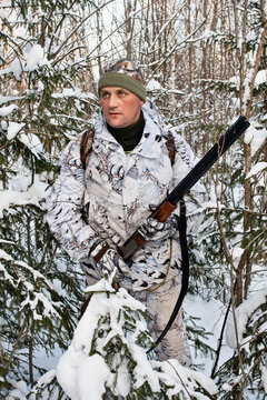 the hunter in the bushes in winter