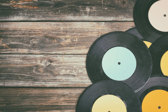 close up image of old records over wooden background , image is
