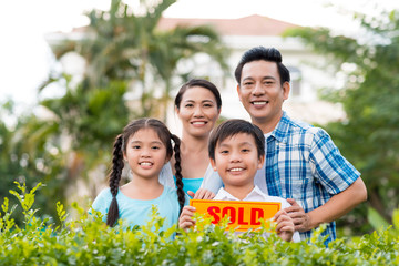 Family with sold sign