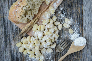Gnocchi on Cutting Board and Rustic Wood Background