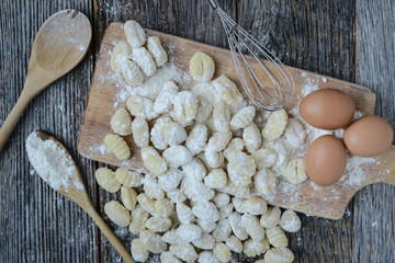 Gnocchi on Cutting Board and Rustic Wood Background