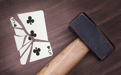 Hammer with a broken card, three of clubs