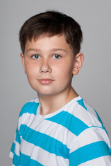 Young boy against the gray background
