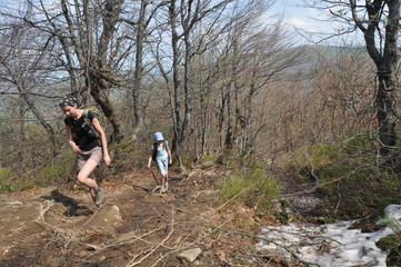 Climbing in the mountains. Family hike on the trail