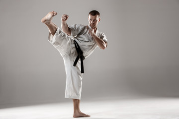 Man in white kimono training karate