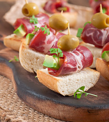 Snack on toast with ham, avocado and olives